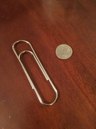 This bad boy is roughly 4" long (quarter for scale) and ready to hold some papers together.